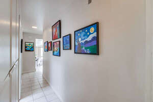 Hallway to bedrooms from living space showcases the owner's personal artwork!