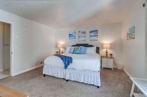 Spacious master bedroom with king bed and the owner's beach art!