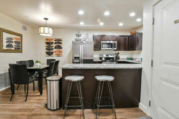 Kitchen and dining area with two bar stools