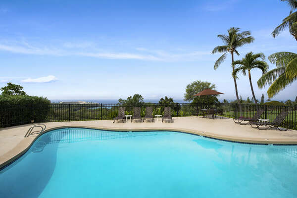 Pool Surrounded by Palm Trees with Ocean Views at Kona Country Club Villa