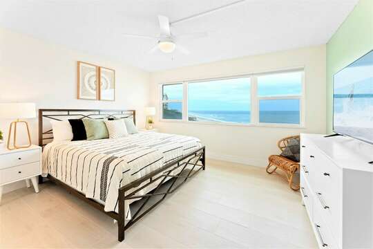 Master bedroom located upstairs - amazon view of the ocean from your king bed (there is also a closet & TV in the room)