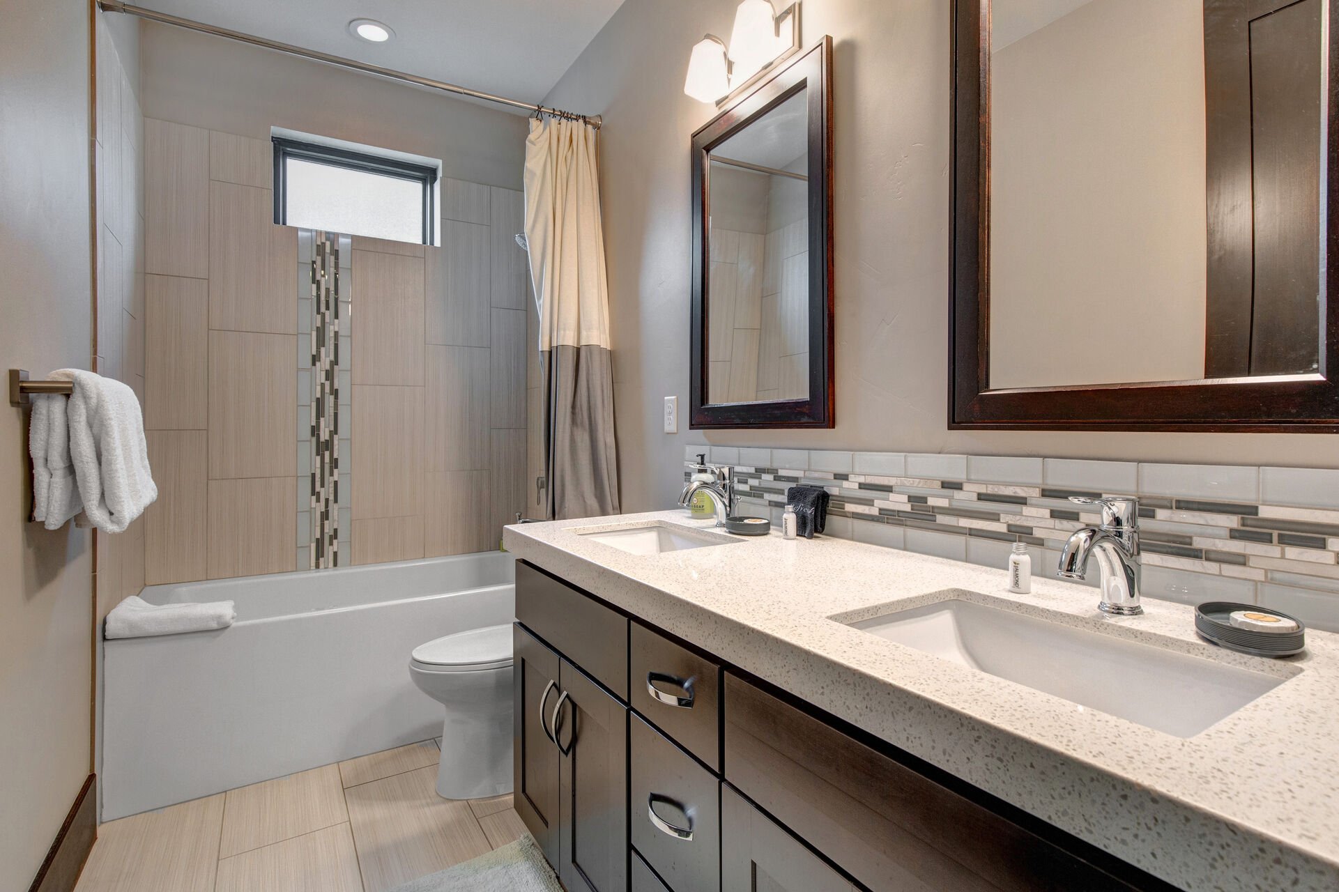 Upper Level Shared Full Bathroom with dual vanity and tub/shower combo