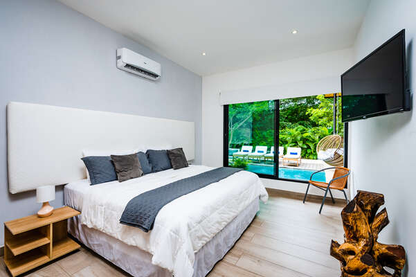 Master Bedroom No 2 with ensuite bathroom and pool view.