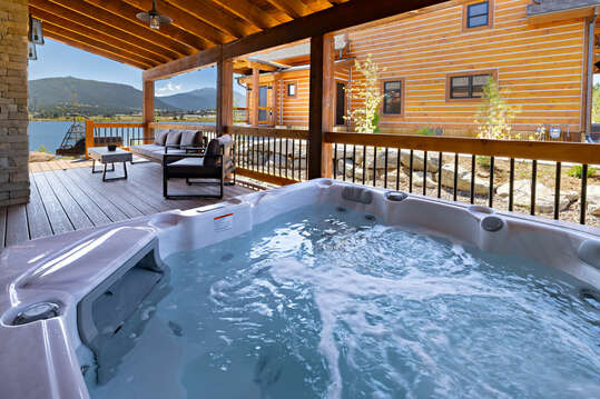Outdoor patio with hot tub and fireplace