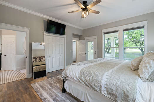 Main level master bedroom with a king bed and 55