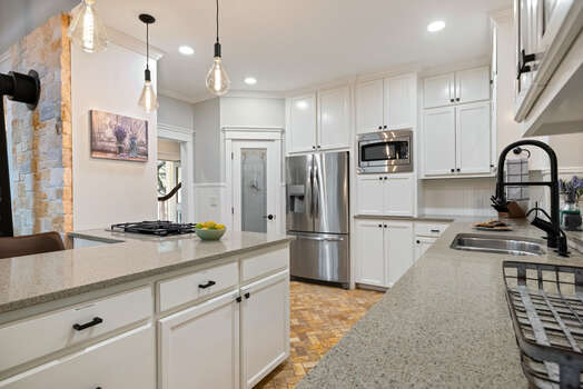 Expansive kitchen with plenty of counter space and stainless steel appliances