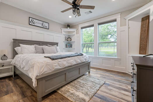Main level bedroom with king bed and 55