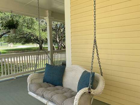 Front porch swing, relaxing in this country ranch setting