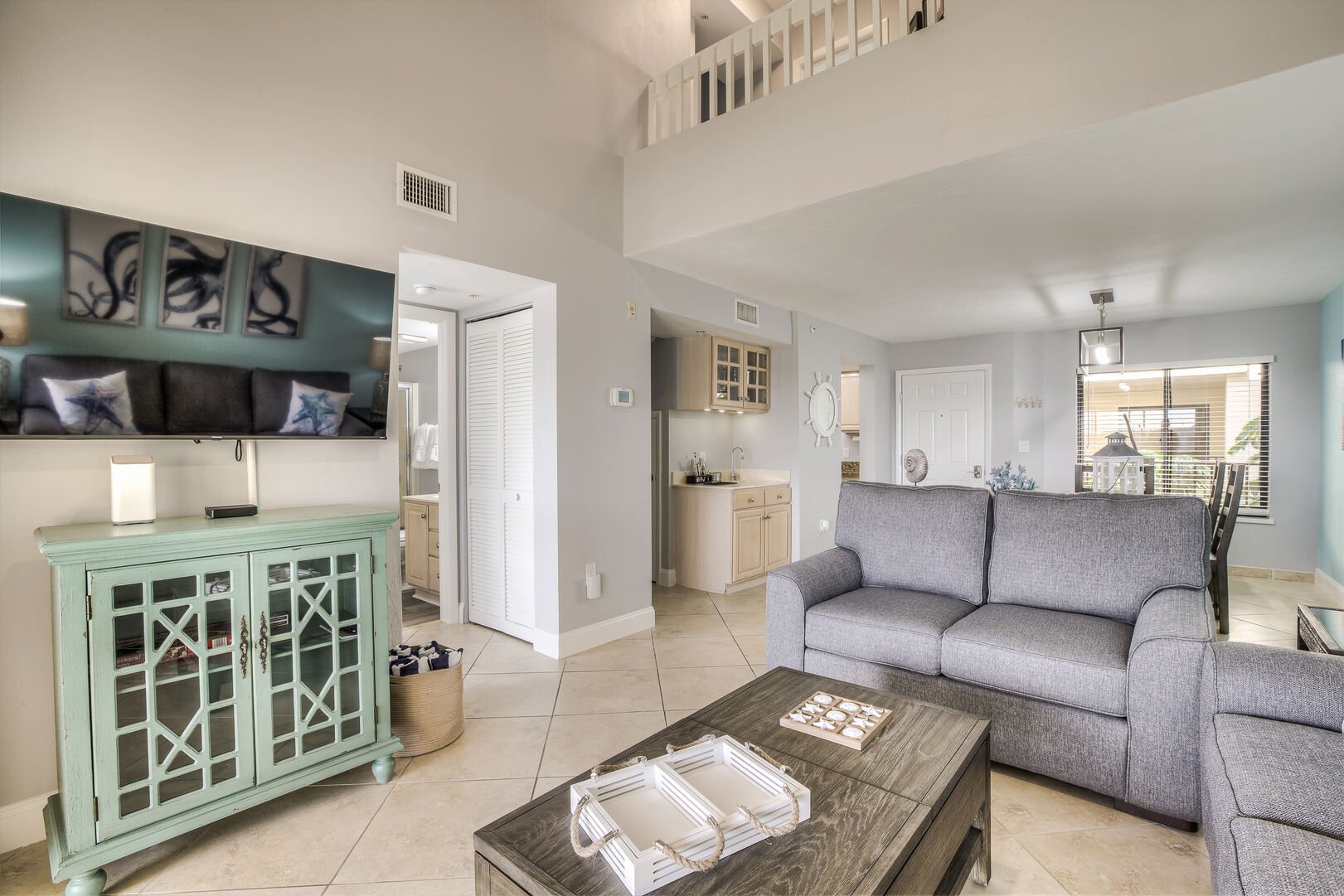 The living area of this Fort Myers Townhouse, with couches, modern TV, and coffee table.