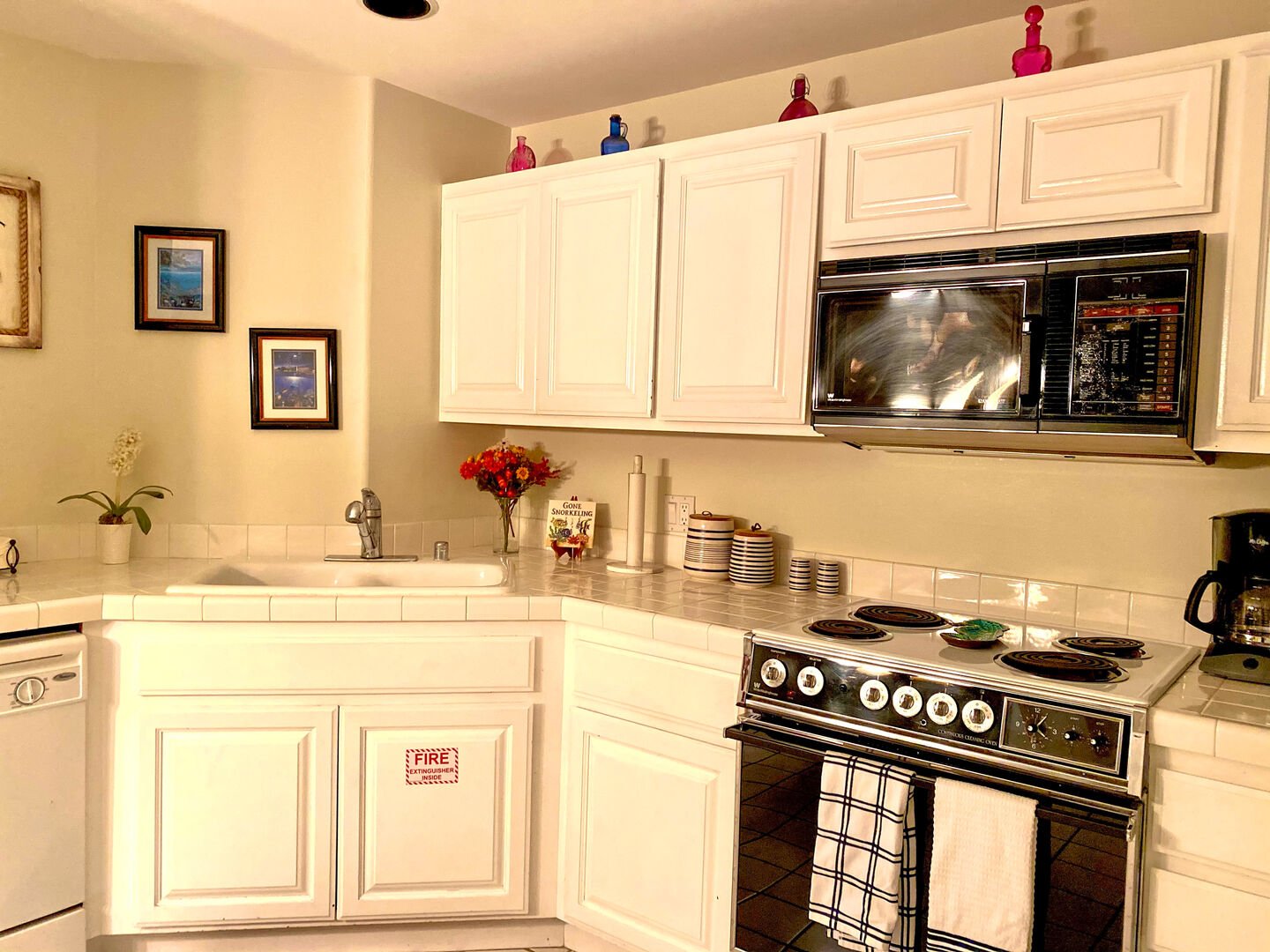 Kitchen with oven, sink, microwave, dishwasher, coffee maker, and refrigerator