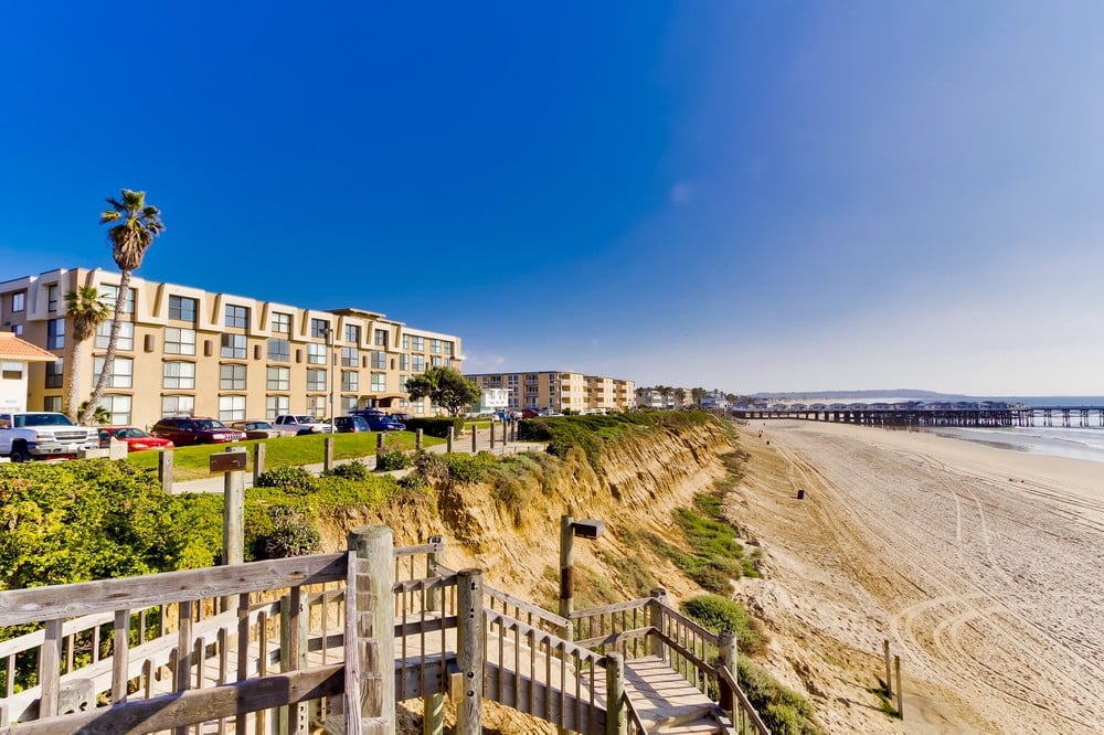 South view of Ocean Point Vacation Rentals, stairs down to the sand, and the Crystal Pier