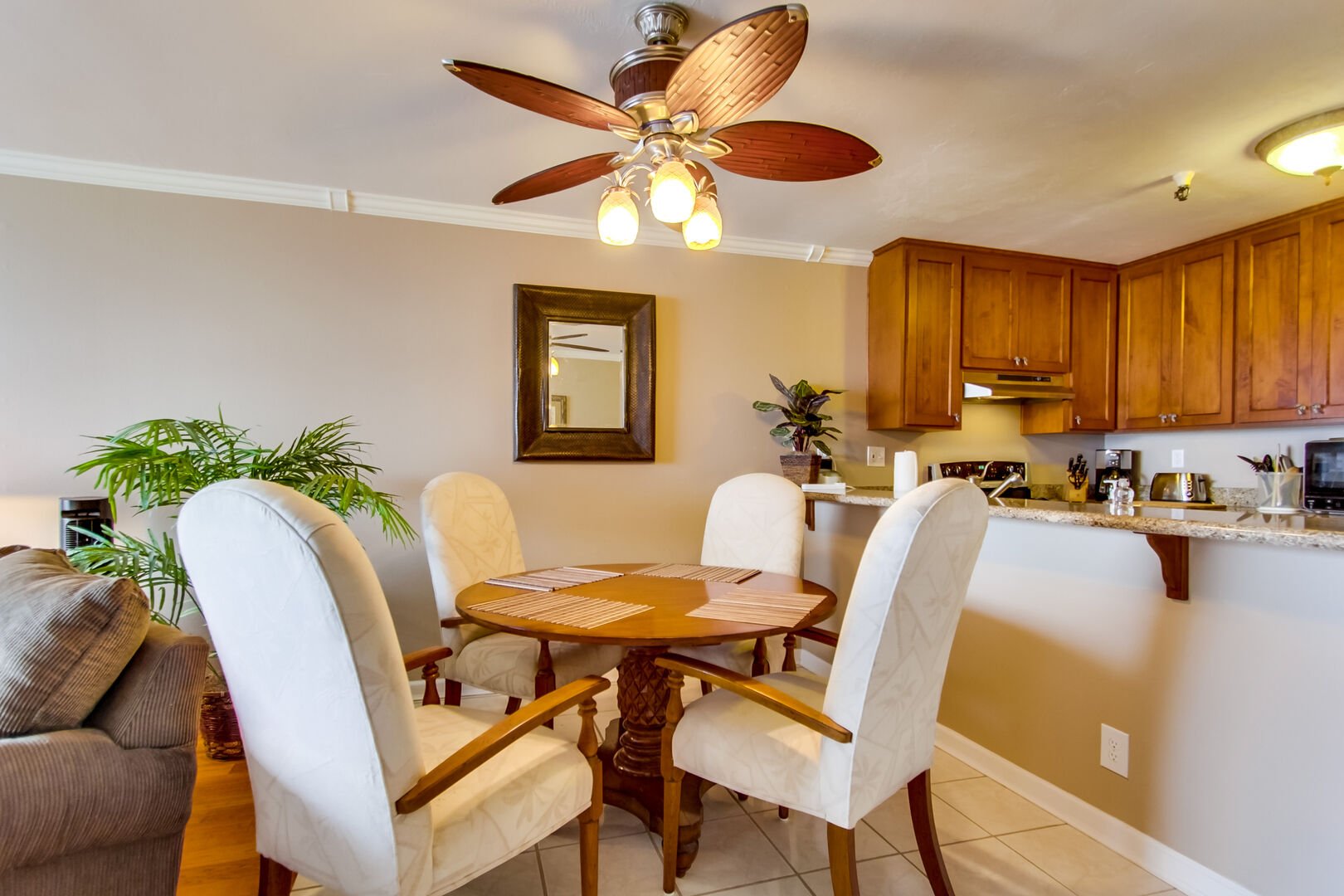 Dining seating for 4 with ceiling fan and over head lighting above.