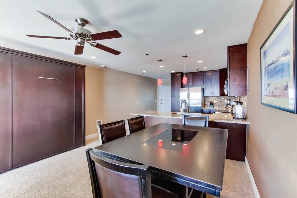 Open style kitchen with dining seating for 4, queen Murphy bed, recessed lighting and ceiling fan