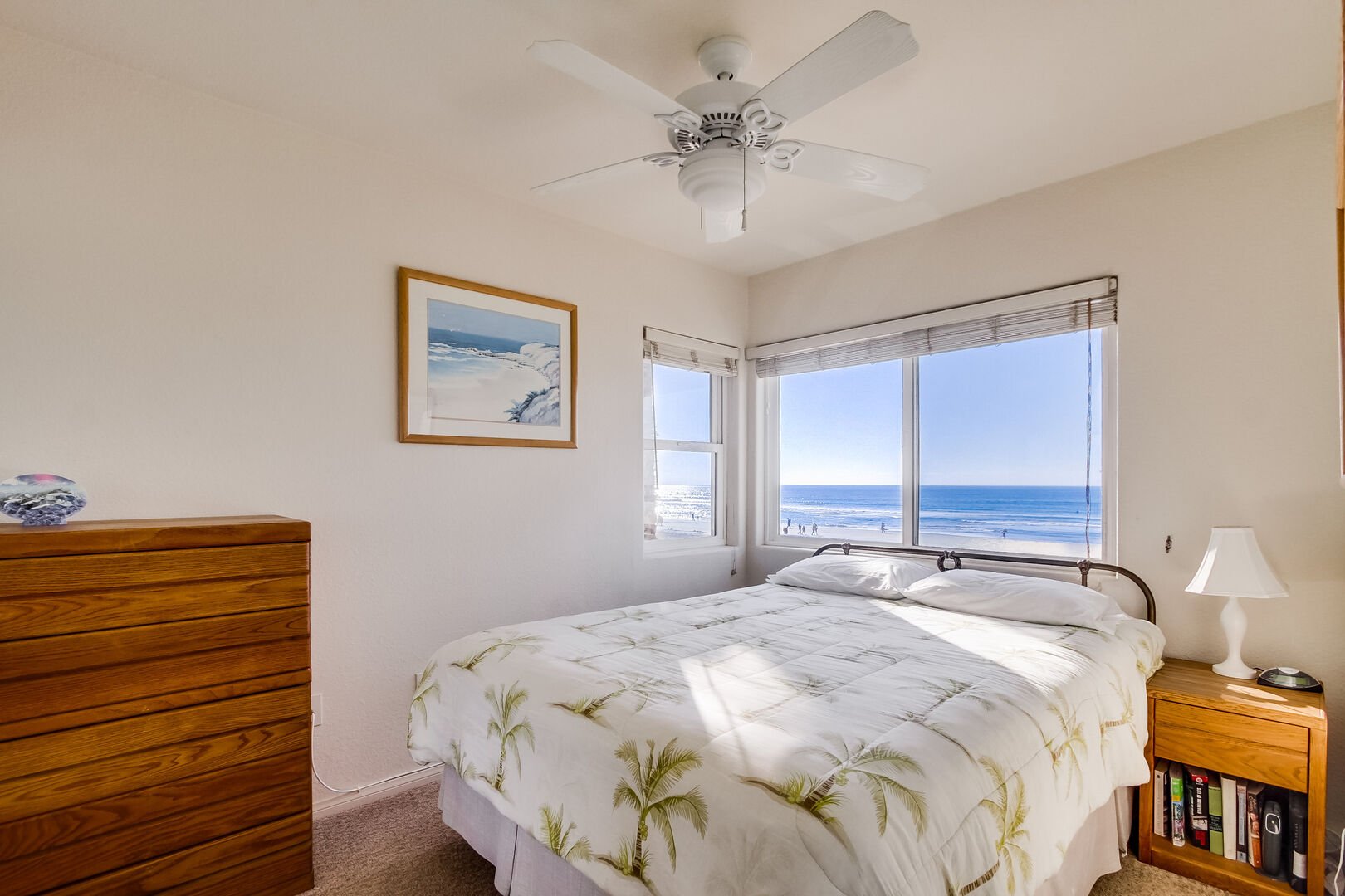 Master bedroom with queen size bed, ocean view, ceiling fan, lamp, TV