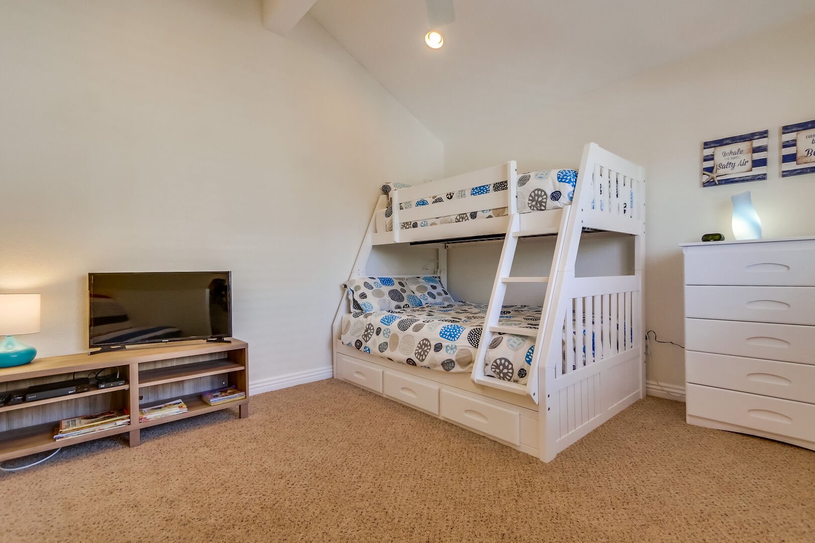 Bunk beds with 1 double size mattress on the bottom and 1 twin size mattress on the top, TV, recessed lighting, ceiling fan, and vaulted ceiling