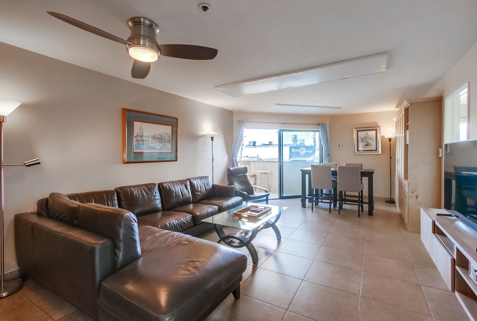 Large sofa, smart TV, dining table, ceiling fan and balcony with corner ocean and boardwalk views!