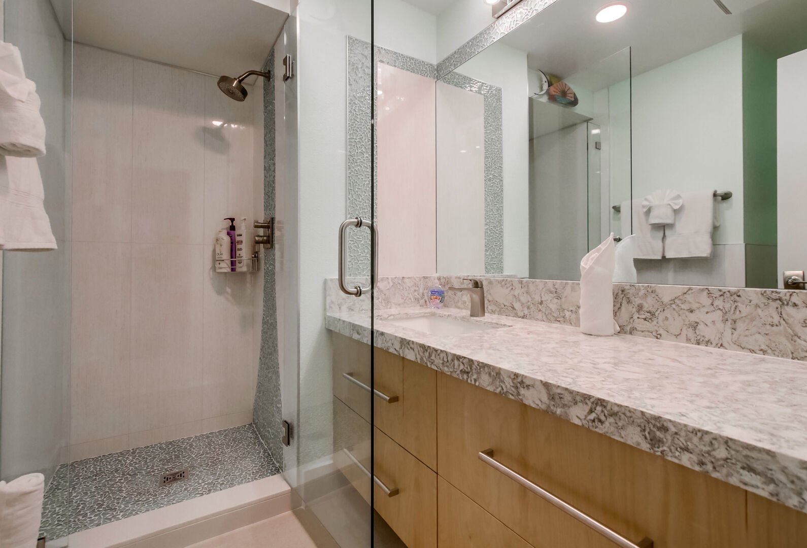Brand new remodeled full guest bathroom! Walk-in shower (pictured: small step into the shower), large vanity, new light fixtures and countertops