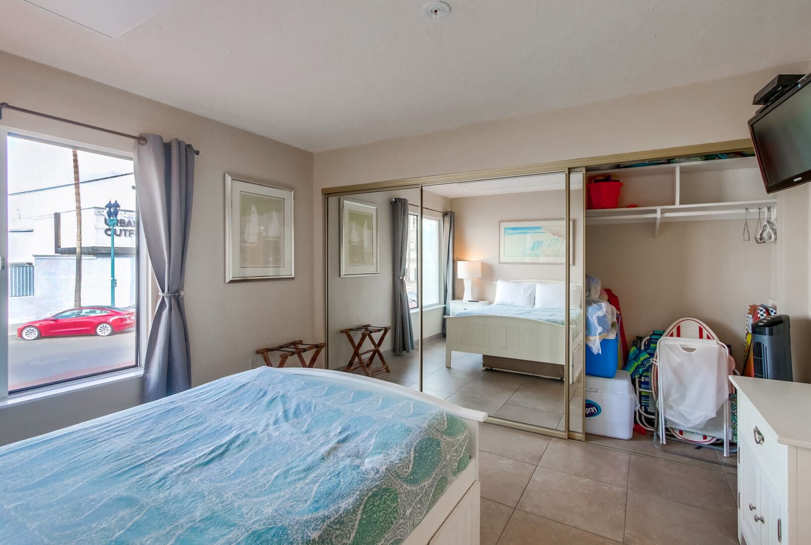 Guest bedroom with double size bed, trundle single bed, large closet, beach accessories, TV and corner views of the beach and boardwalk action!