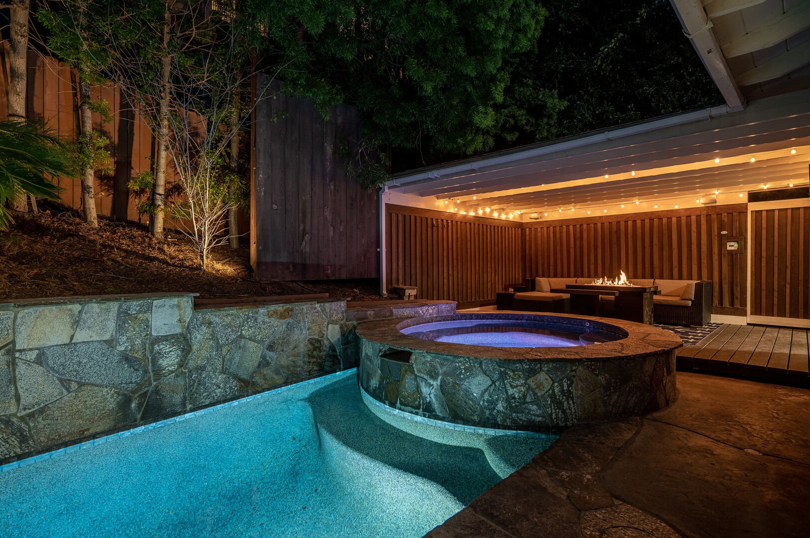 Hot tub jacuzzi with rejuvenating jets and bubbles under a wood cabana