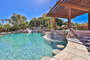 Huge resort style pool, with swim up bar seating, sunken grill area, multiple waterfalls,  large tanning/baha shelf, and slide