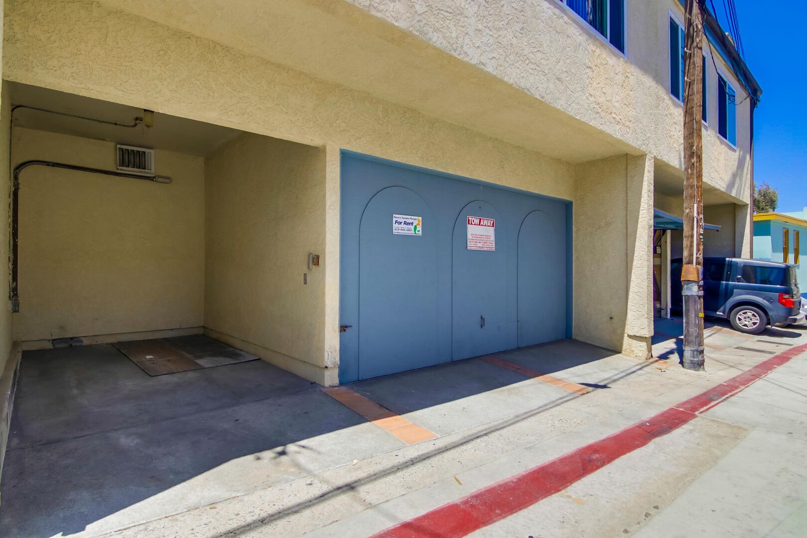 Compact vehicle parking space to the left of garage, first come first serve