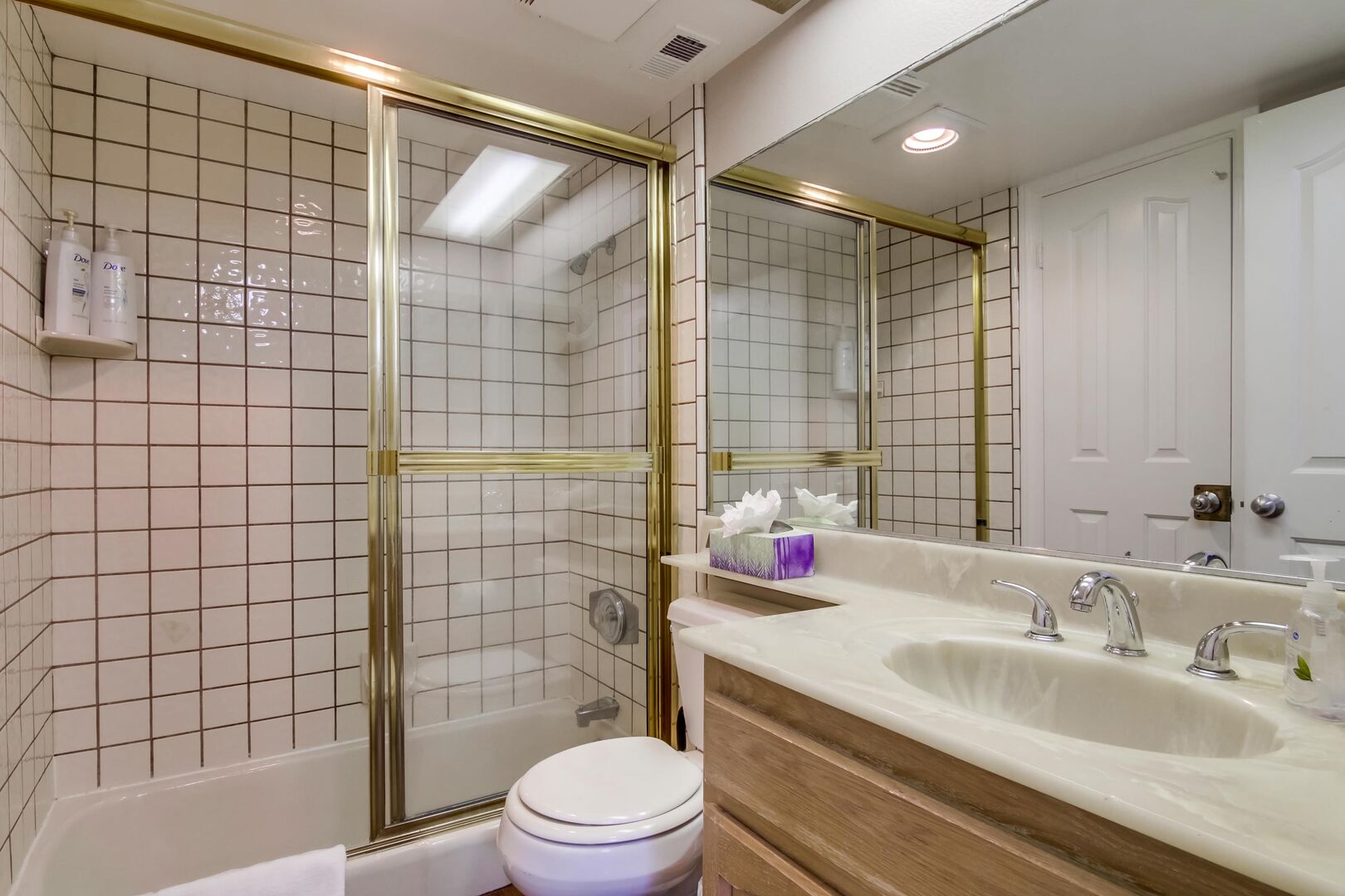 Downstairs bathroom with vanity sink and tub/ shower combination