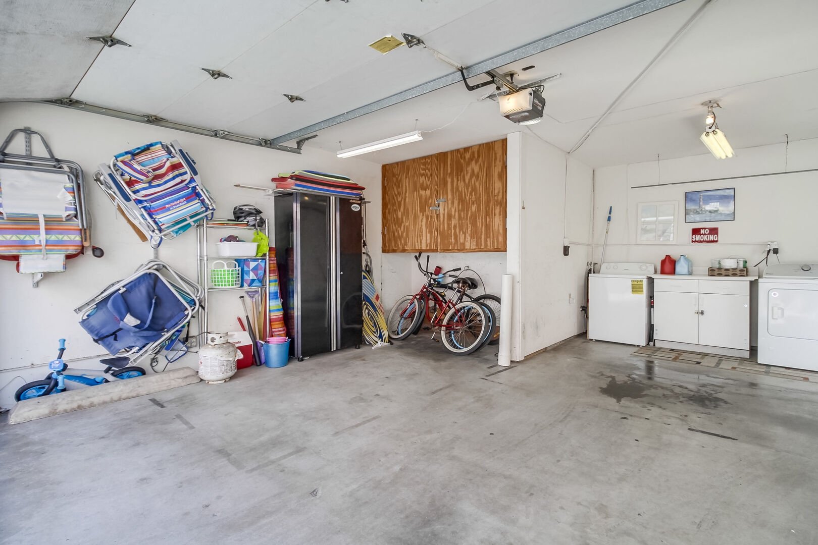 Garage parking for 2 SMALL cars with washer and dryer and beach accessories including chairs, boogie boards and beach umbrella. Bikes and extra propane also provided. 1 LARGE VEHICLE FITS COMFORTABLY