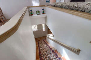 Stairs lead up to the kitchen, dining area, living room, balcony/patio and master bedroom suite