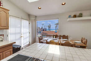 Interior dining table for 6 guests with a view of the ocean from the window!