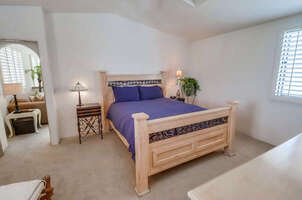 Calming and open master suite with queen bed, ceiling fan, large walk-in closet and en-suite full bathroom
