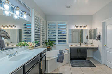 Remodeled primary bath features a luxurious garden tub and new walk in shower.