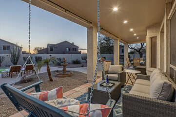 The enclosed backyard offers a variety of activities and seating choices.