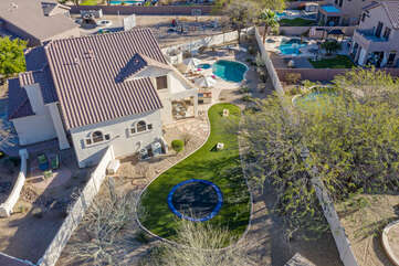 The backyard is large and has a grassy area for recreational activities.