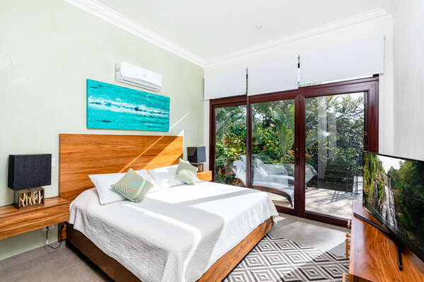 Bedroom 2 with access to the garden and the pool