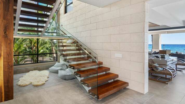 Suspended staircase with structural glass landing, custom glass railings