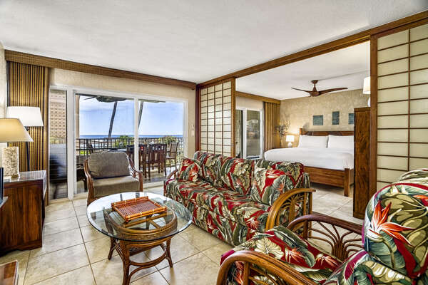 Living room at this Kona condo vacation rental with couch and two chairs.