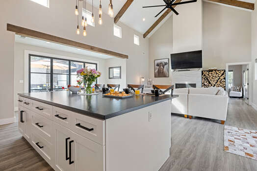 Living room, dining room and center island in gourmet display kitchen