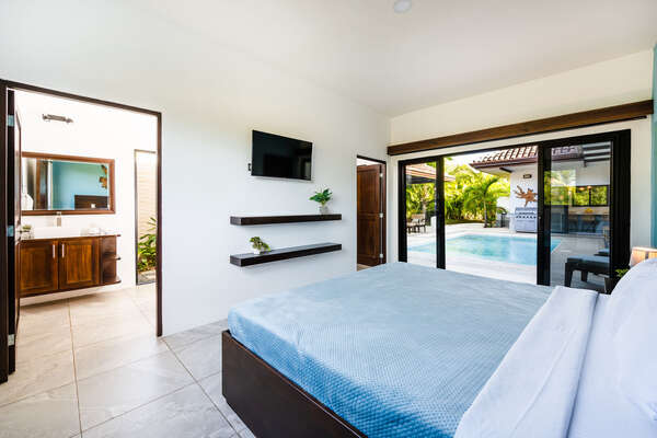 Master Bedroom 1 with One King Bed, in tropical wood, Ensuite Bathroom, Dressing AC and Pool Access