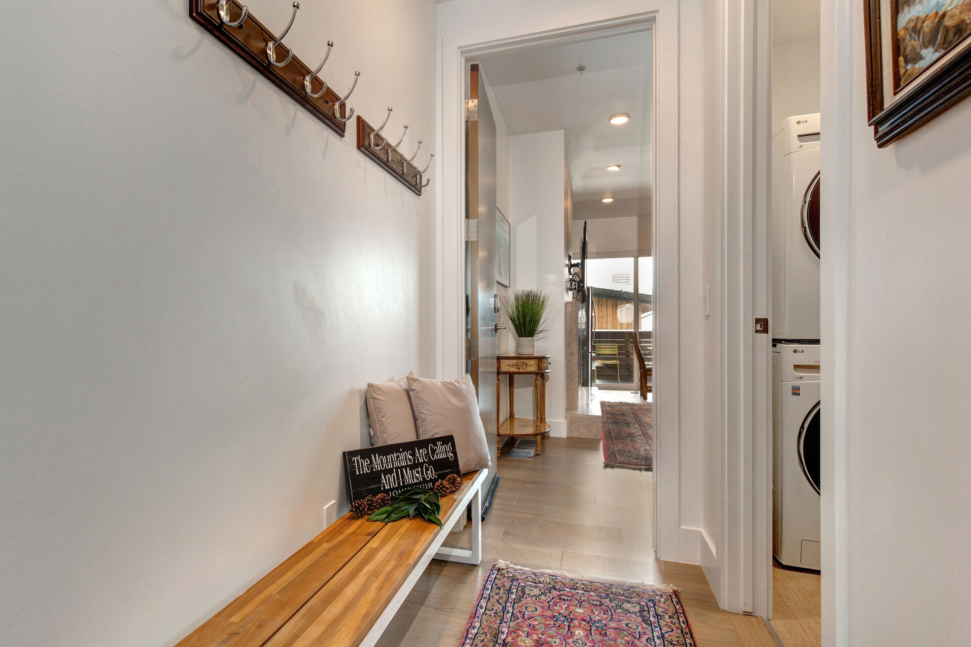 Shared Interior Hallway with a Bench and Coat Racks, Shared Laundry and Condo Entry Door
