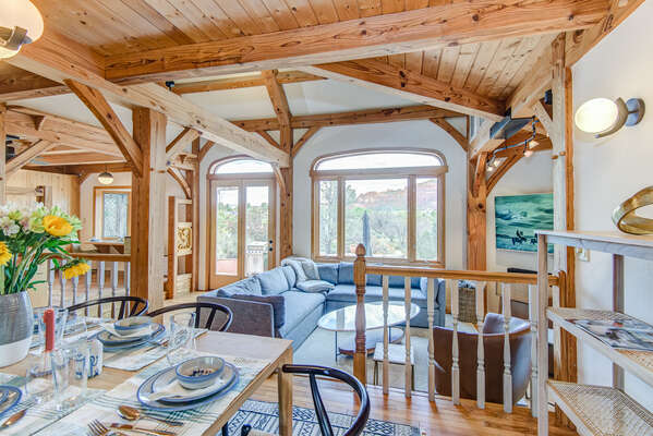 Dining and living area with ample seating, vaulted ceilings, and views of the scenic surroundings