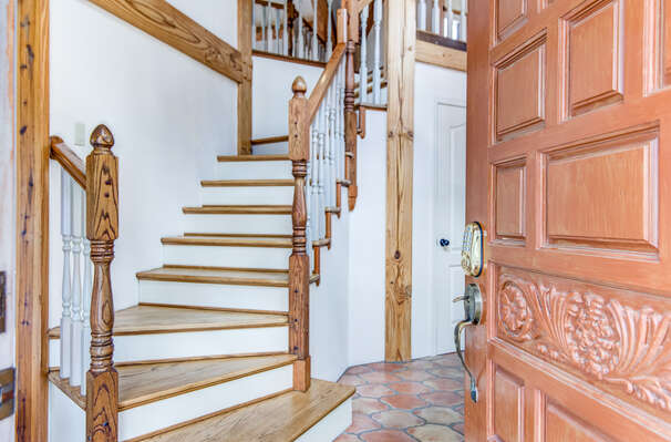 Main entrance with immediate access to stairway to upper level