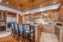 Gourmet Kitchen with granite countertops, Sub-Zero fridge, stainless steel Wolff appliances, bar seating for four, and wine fridge