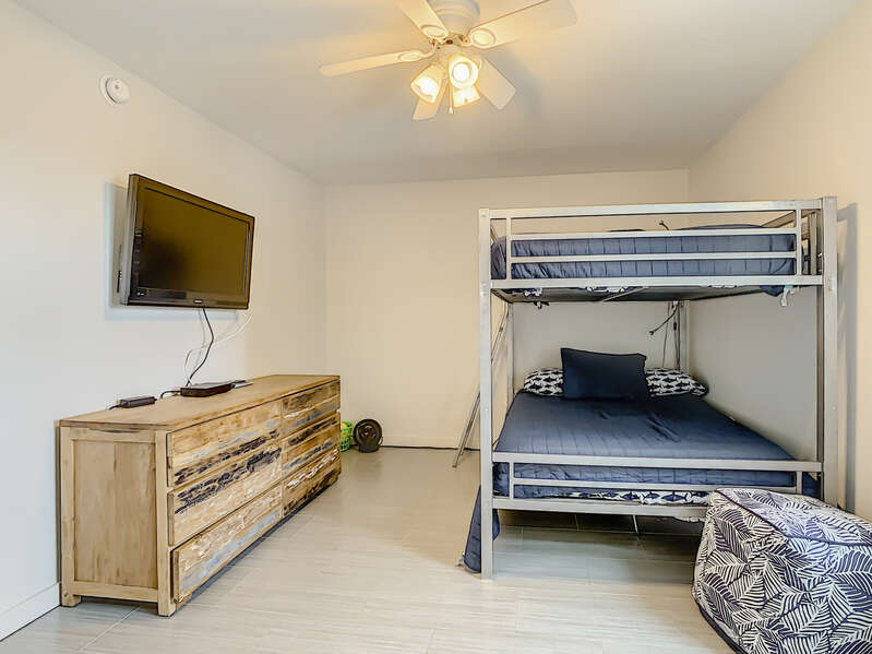 Bedroom with bunkbeds and a tv