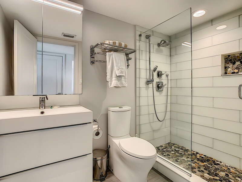 A bathroom with a walk in shower