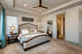 Main level master bedroom with king bed, sitting area, smart TV, and en suite bathroom