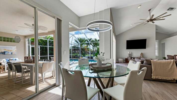 Seating for six at the kitchen table with expansive views of the pool and canal