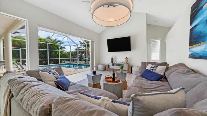 Incredibly comfortable family room with views of the pool and canal beyond