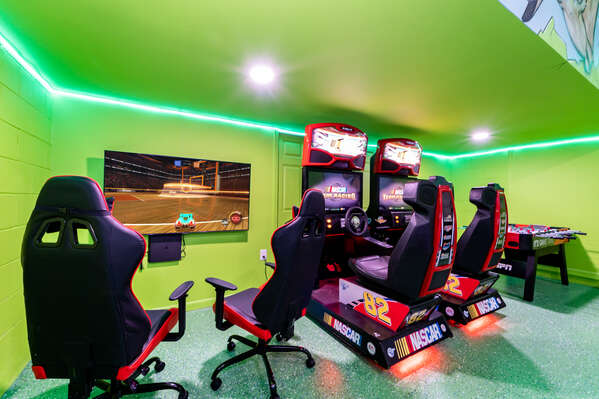 Games room showing NASCAR racing arcade and PS4 game console