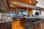 Gourmet Kitchen with Granite Counters and an Island with Seating for Six