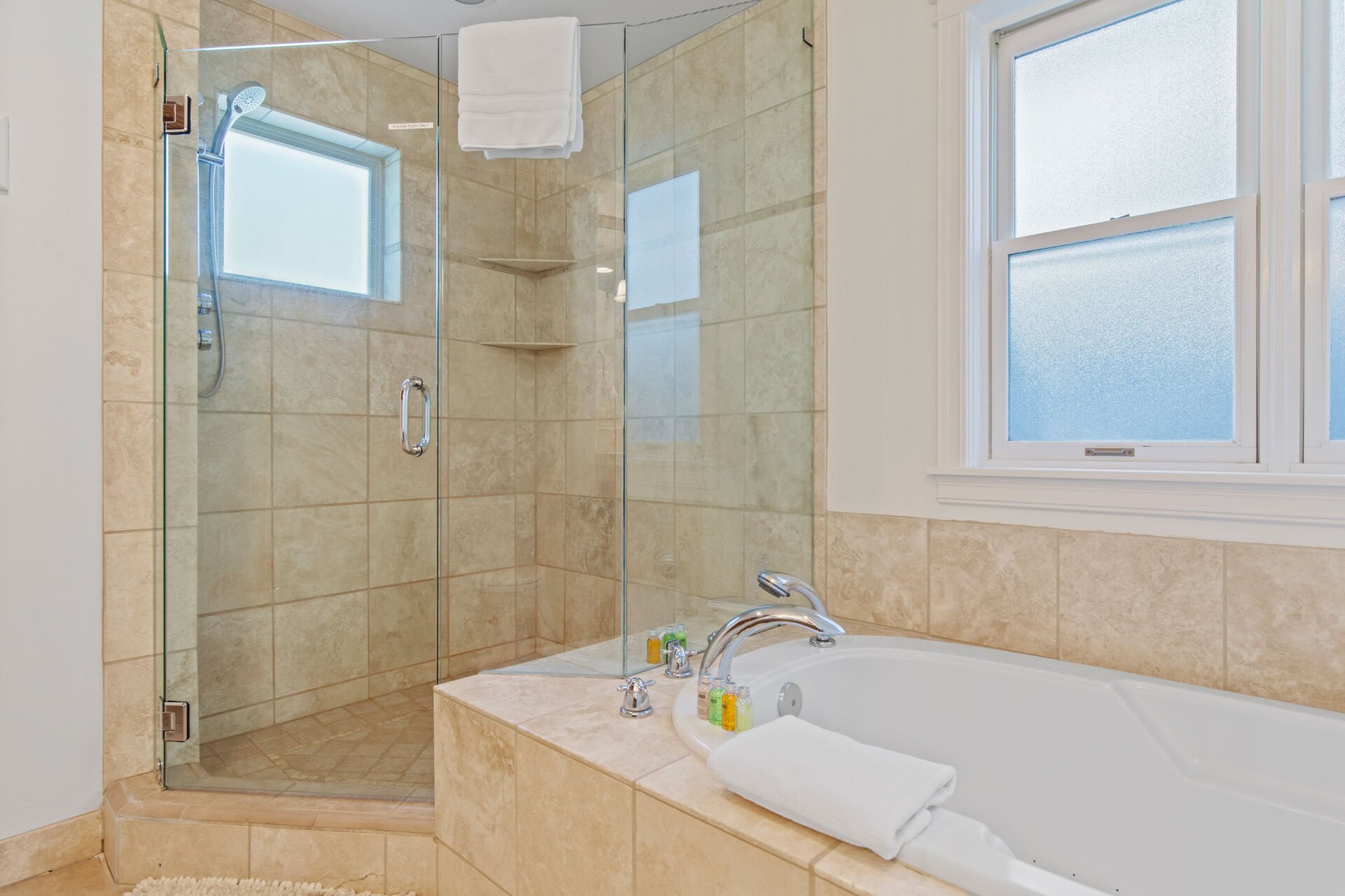 Master Bathroom with over-sized tile shower, jetted tub, and dual vanities
